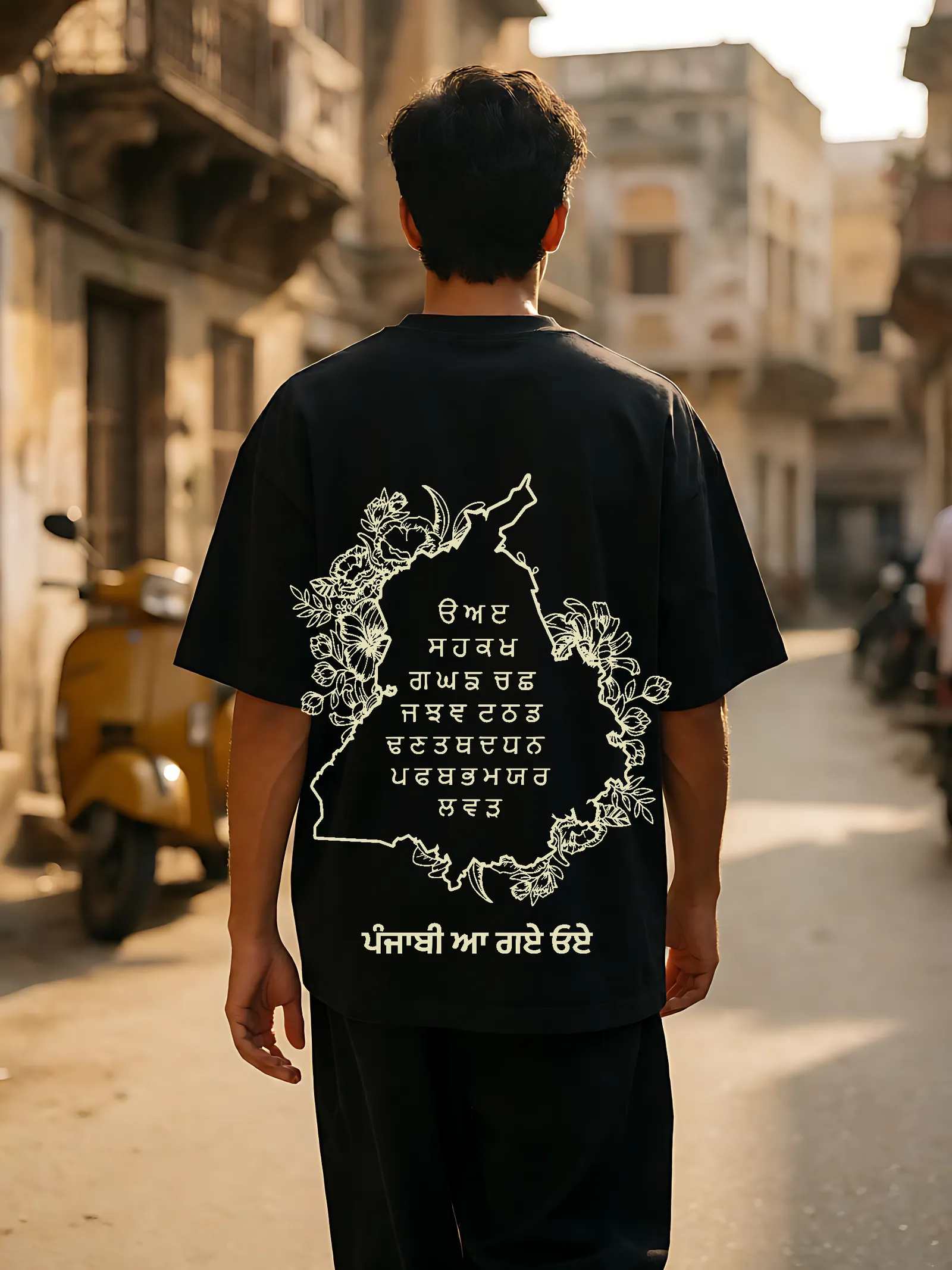 Punjabi Aa Gaye Oye tee worn — full back print in the street
